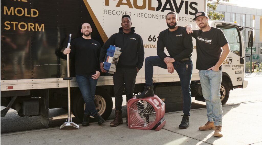 Paul Davis Restoration of Bakersfield emergency response team standing beside restoration truck with water damage drying equipment and cleanup tools
